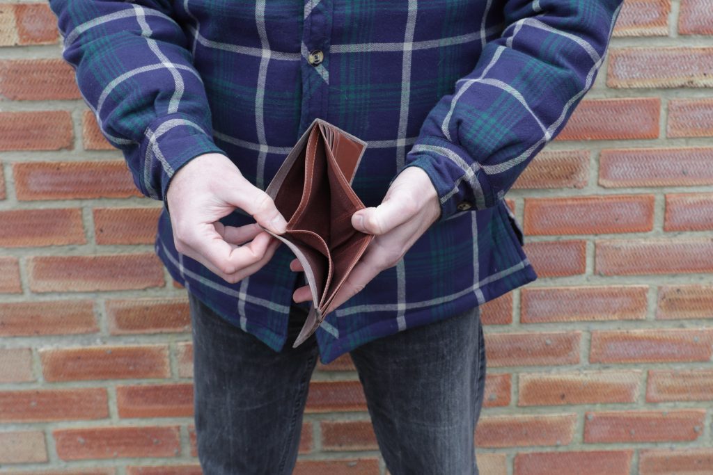 man showing lack of money to pay car finance