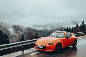 orange Mazda Mx-5 on road