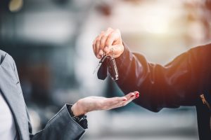 male hand handing over keys