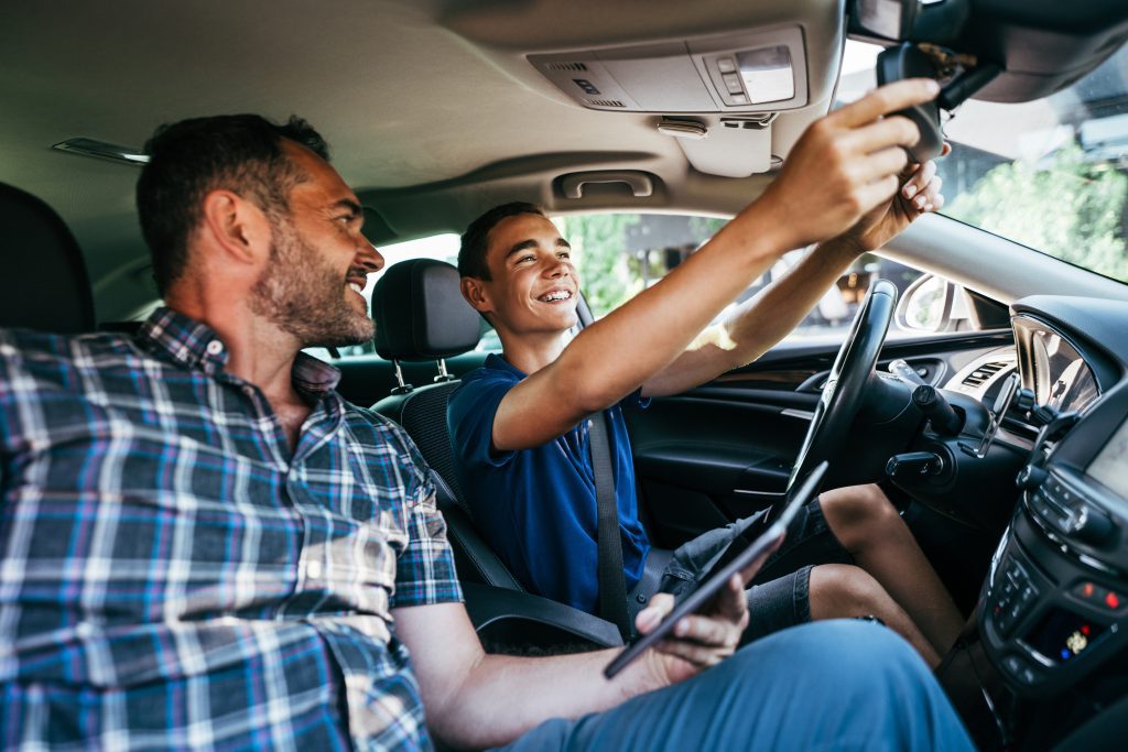 man test driving a car