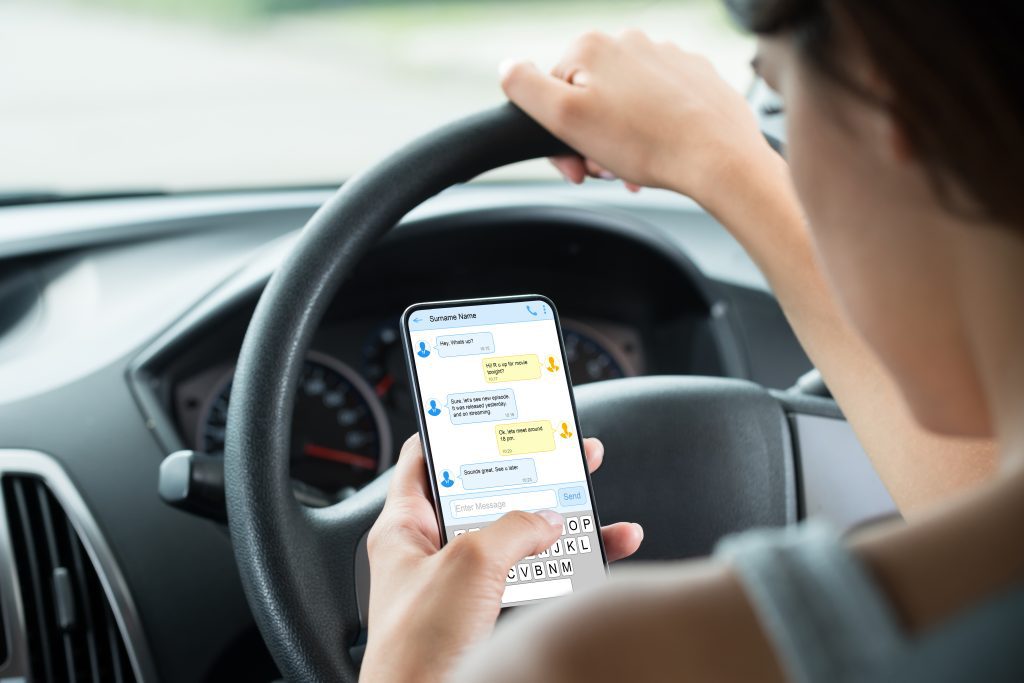 woman texting whilst driving