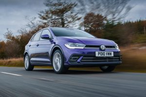 Uber driver holding smartphone in car 2022 Volkswagen polo new driver car