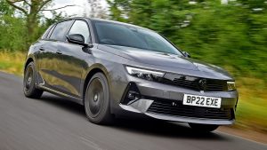 Mercedes E-Class 2022 front driving Vauxhall Astra 2022 grey