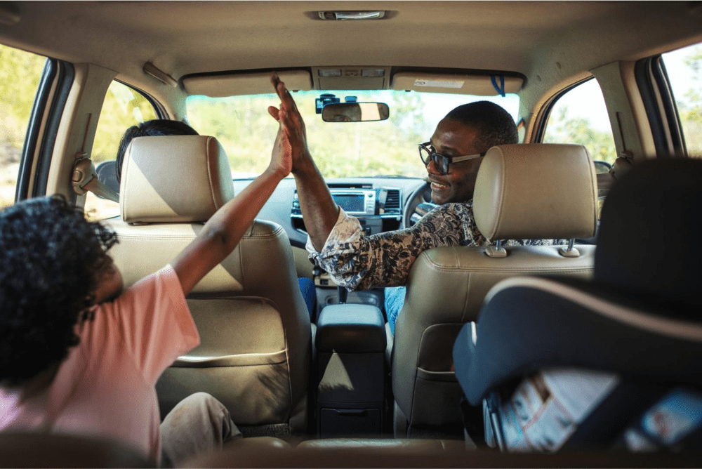 happy family in car going on roadtrip UK