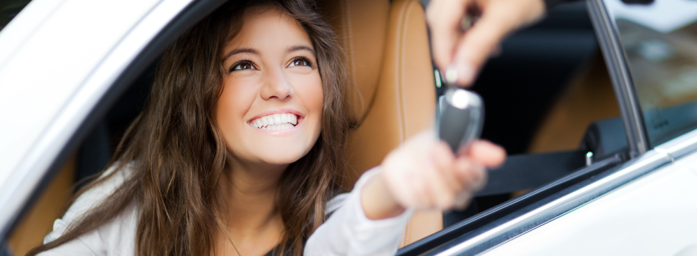 Young girl receiving new car keys