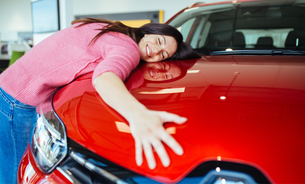 woman hugging her new car