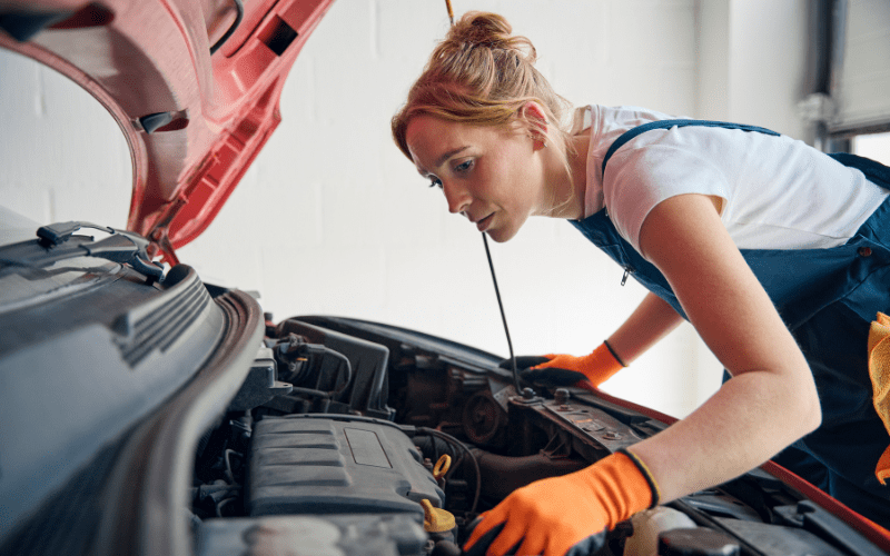 woman under bonnet of car