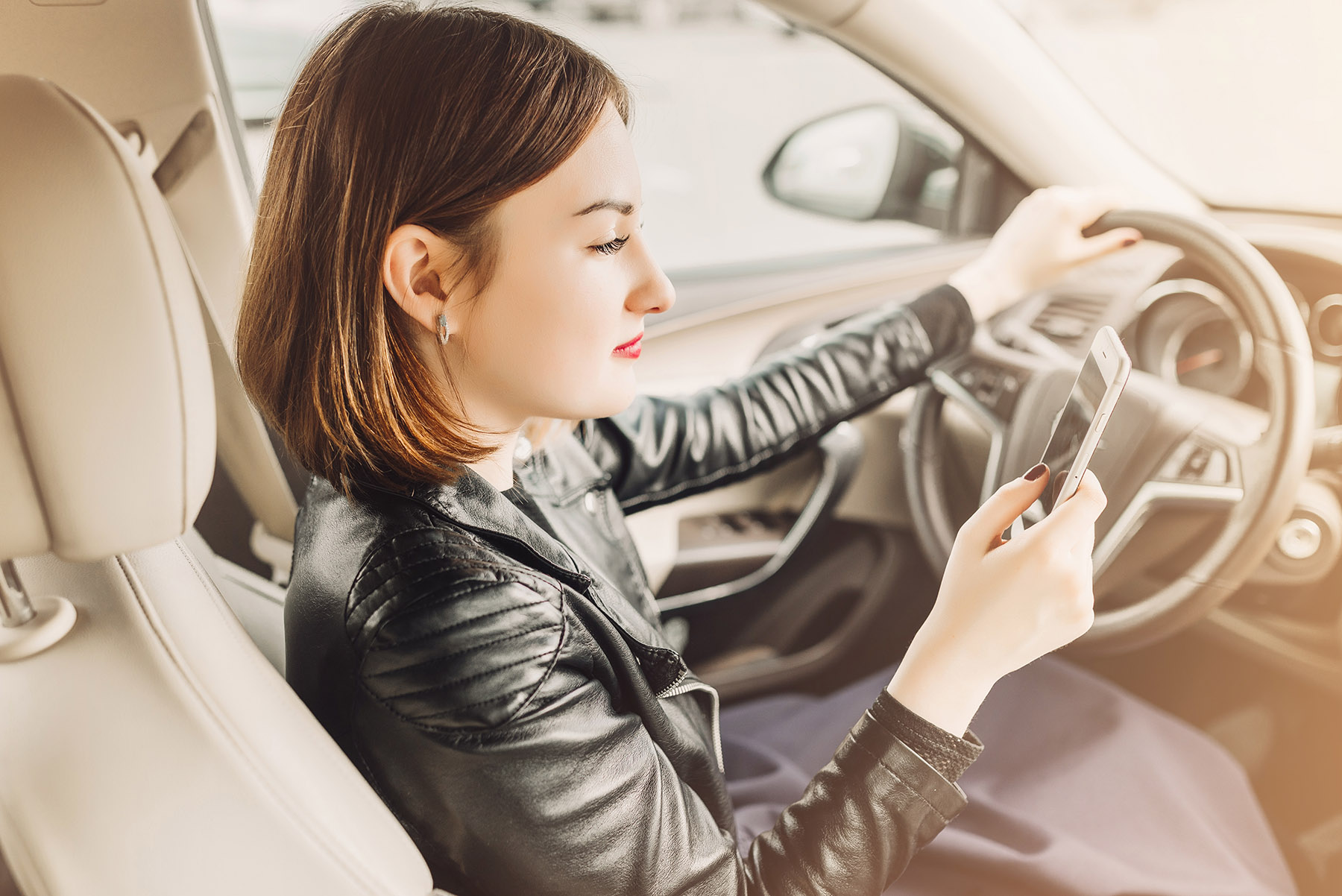 Woman in her car using a mobile phone